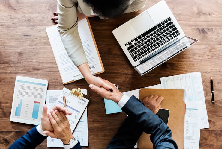 Business meeting with laptops and papers
